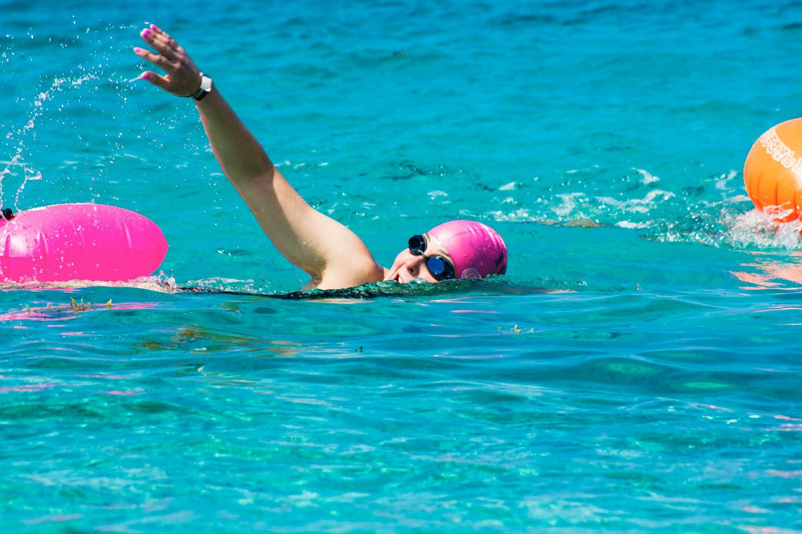 https://www.pexels.com/photo/a-woman-wearing-goggles-and-swimming-cap-while-swimming-in-a-pool-11120192/