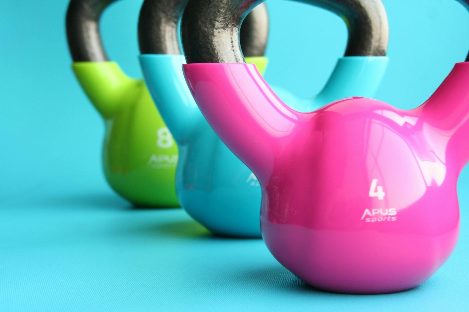 https://www.pexels.com/photo/green-blue-and-pink-kettle-bells-on-blue-surface-221247/