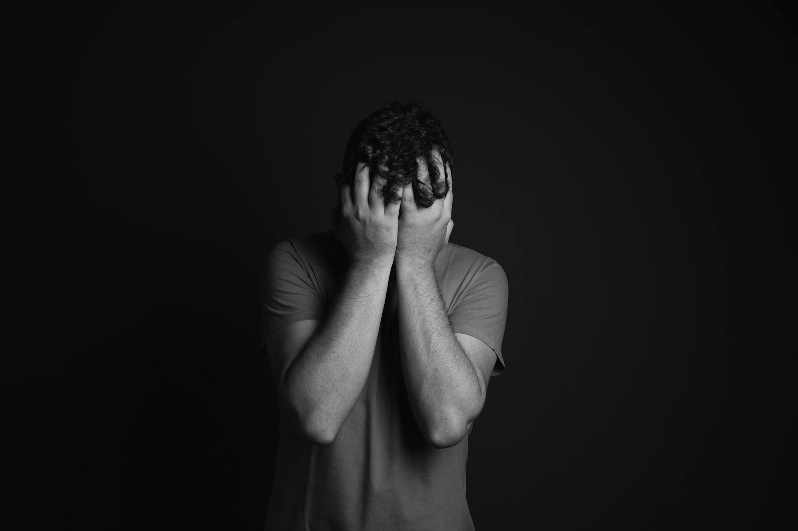 https://www.pexels.com/photo/gray-scale-photo-of-man-covering-face-with-his-hands-3601097/