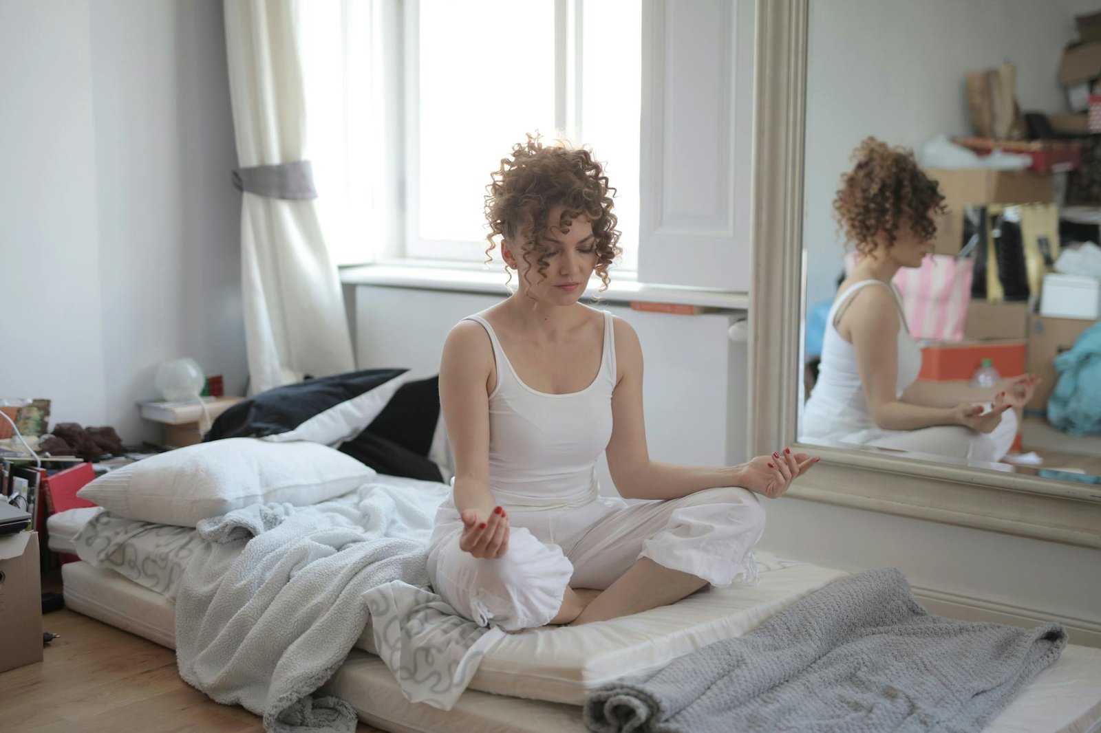 https://www.pexels.com/photo/calm-woman-in-lotus-pose-meditating-after-awakening-at-home-3791634/