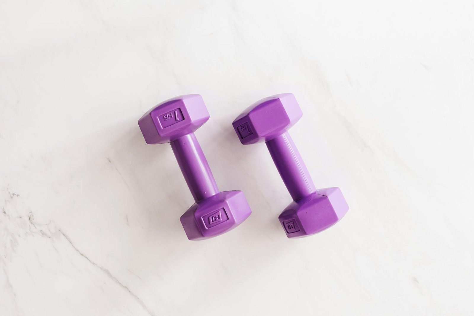 https://www.pexels.com/photo/purple-all-cast-dumbbells-on-marble-surface-4397833/