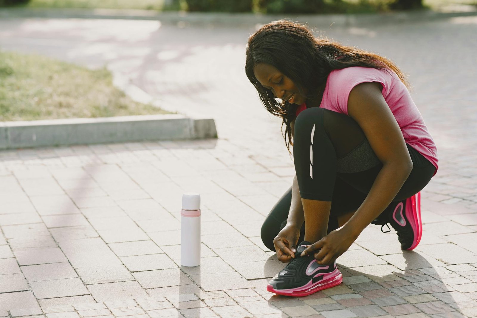 https://www.pexels.com/photo/woman-in-pink-shirt-tying-her-shoelace-5163851/